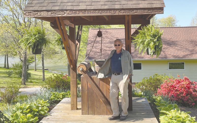 Warren Hencely stands beside the well house he built after moving to his Mt. Airy home. BRIAN WELLMEIER/Staff
