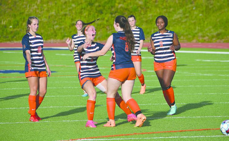 Habersham Central’s Piper Turner (left) and Emylie Nichols celebrate a goal during the Lady Raiders’ dominant first-round playoff win. LANG STOREY/Staff