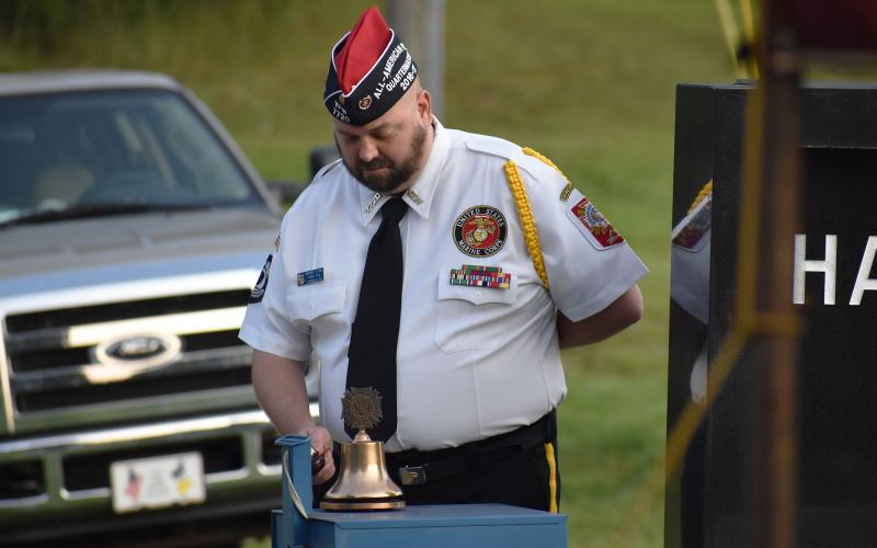 VFW Quartermaster Michael A. Dale rings the bell for each event of 9/11 read off during the ceremony. MATTHEW OSBORNE/Staff